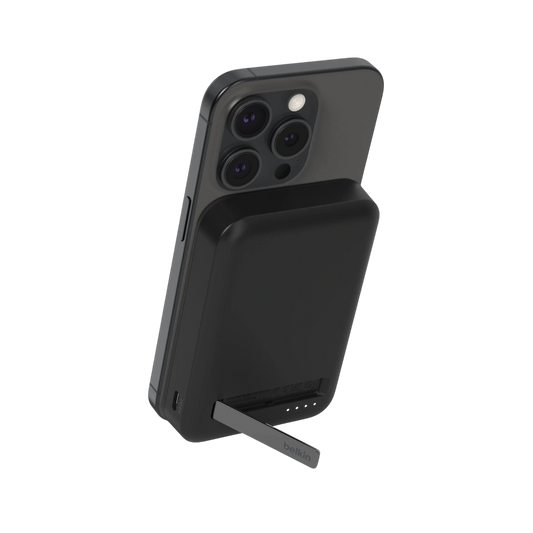 Belkin BoostCharge Pro Qi2 magnetic power bank in black attached to an iPhone with kickstand open